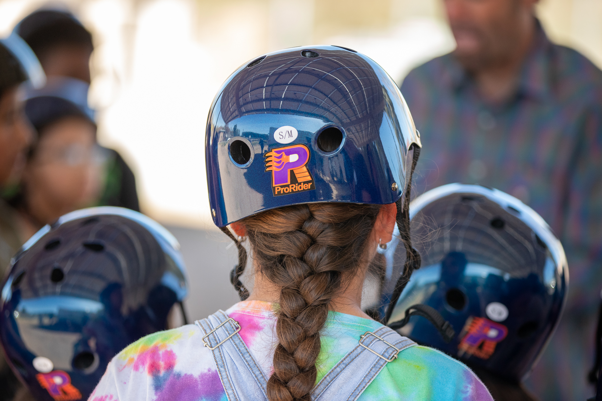 Back view of a girl wearing a bike helmet and braid