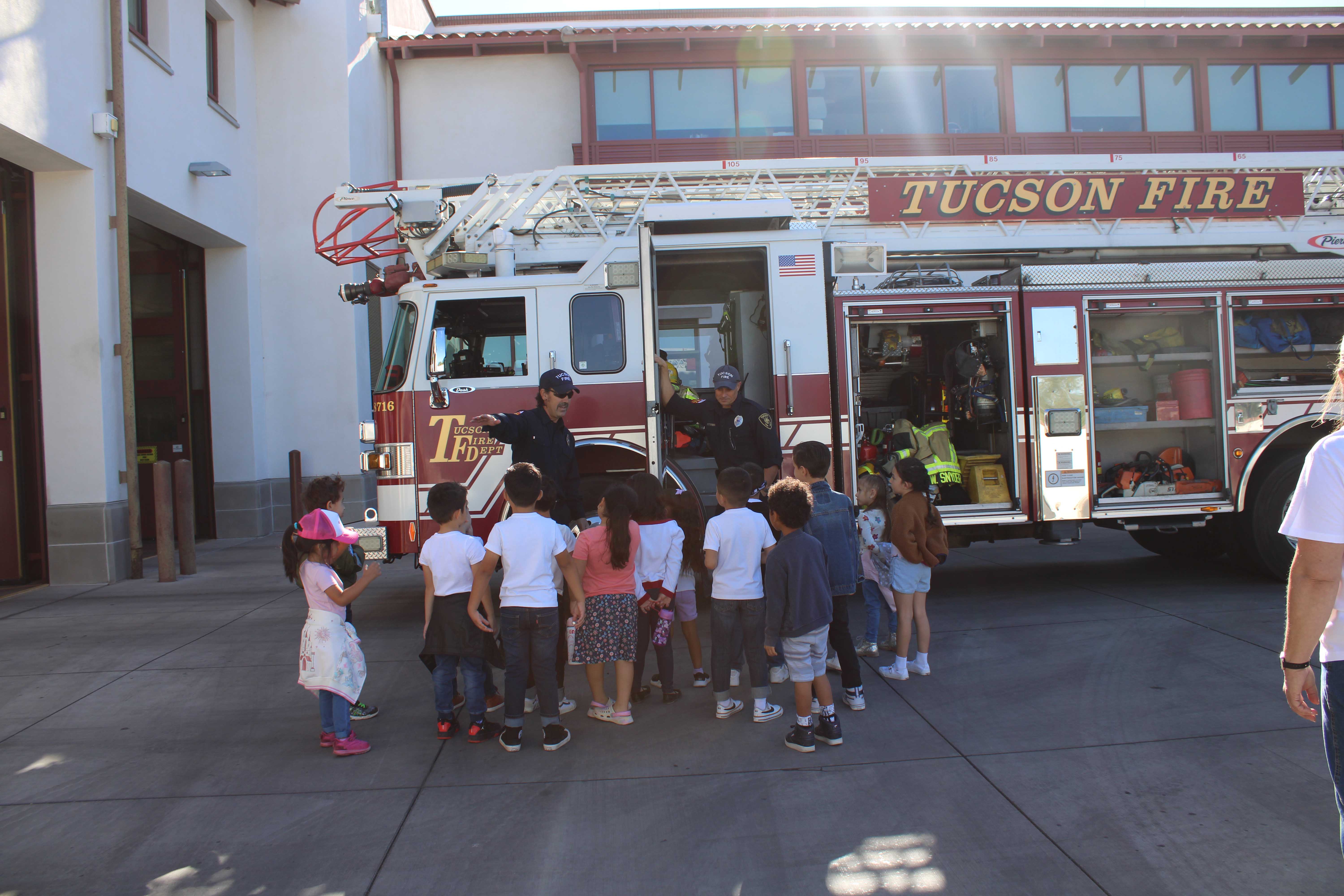 Kindergarteners gather around a fire truck