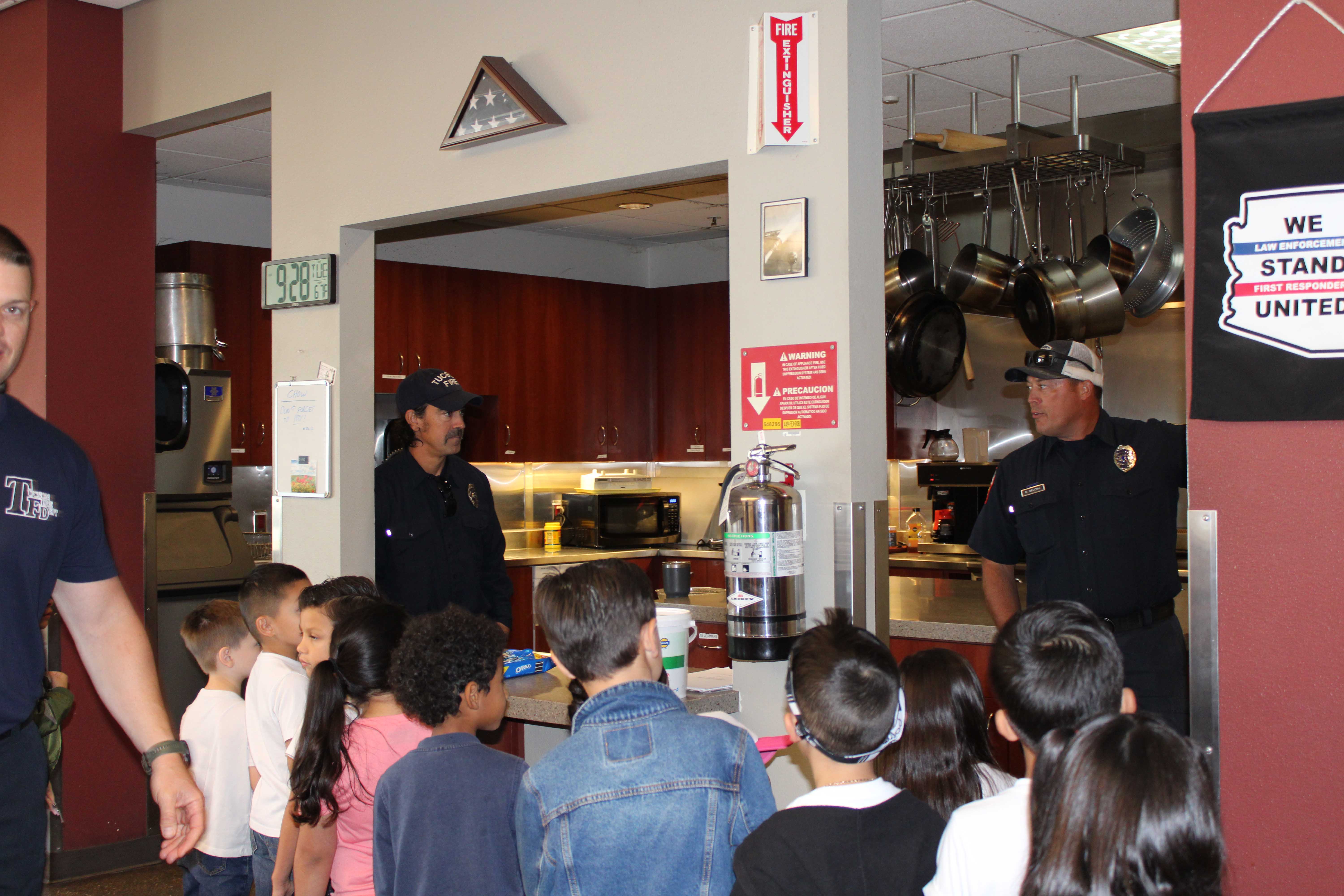 Firefighters show students the firehouse kitchen