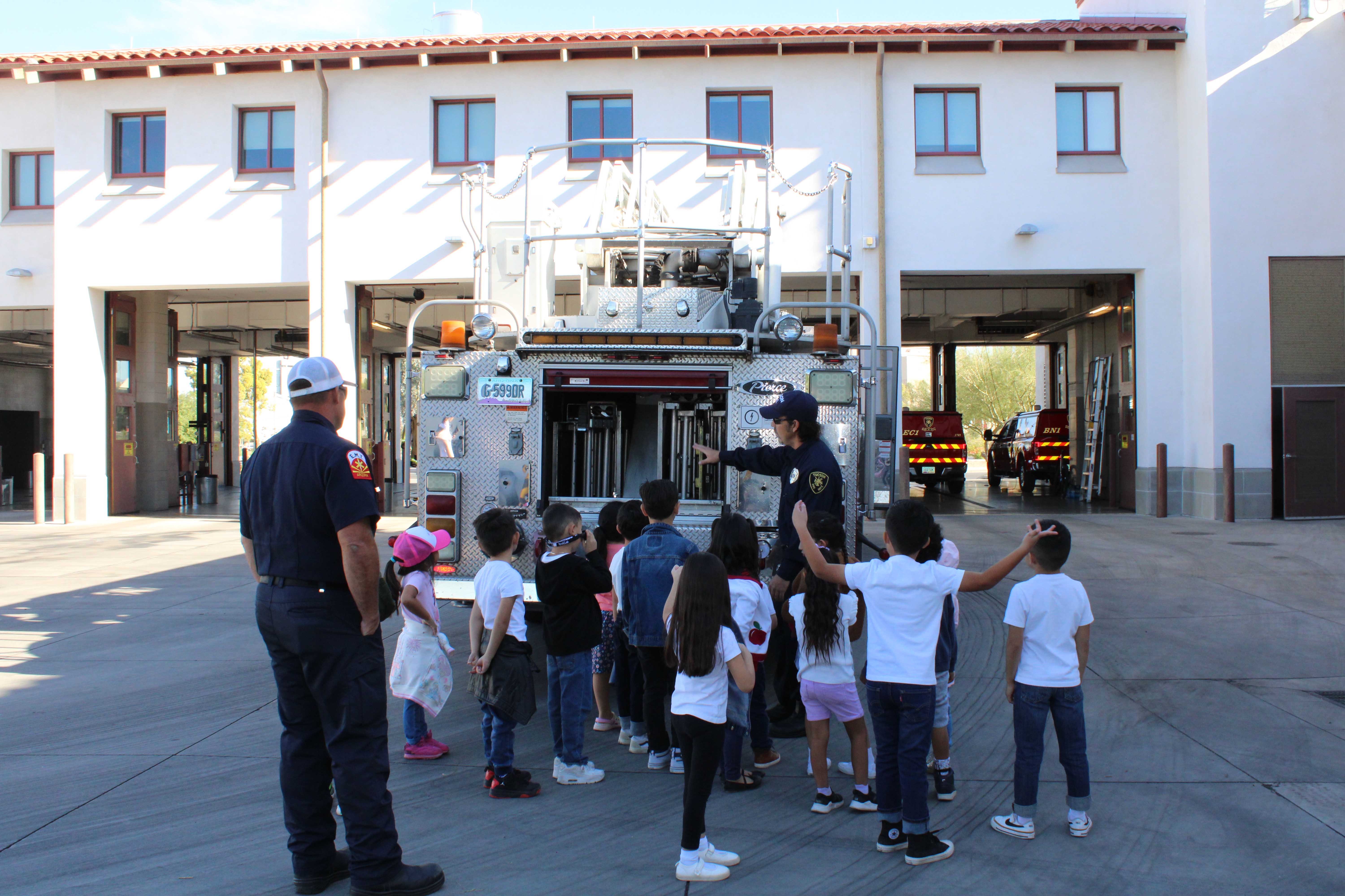 Students gather around the back of the fire truck