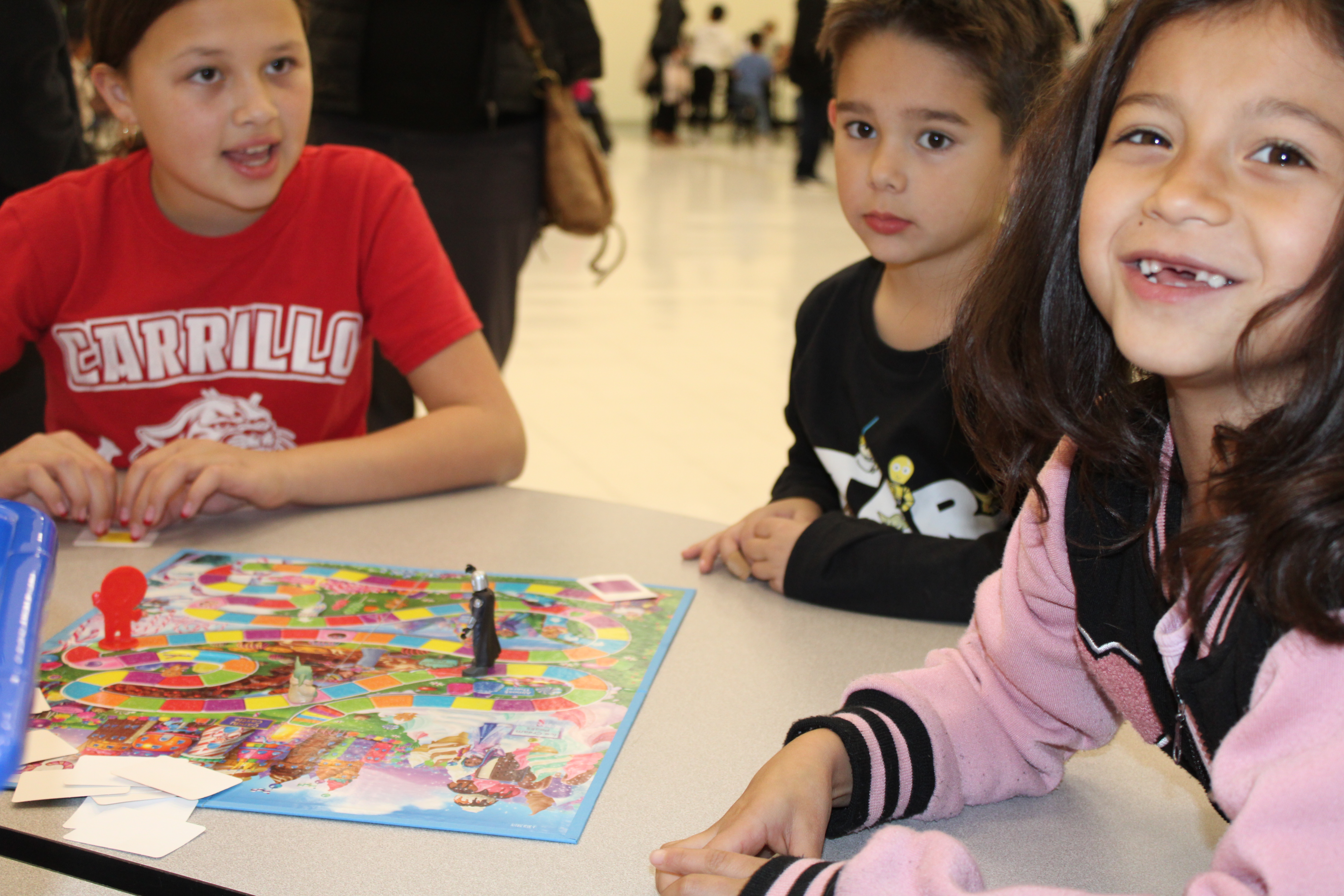 Three students play a game of Candy Land