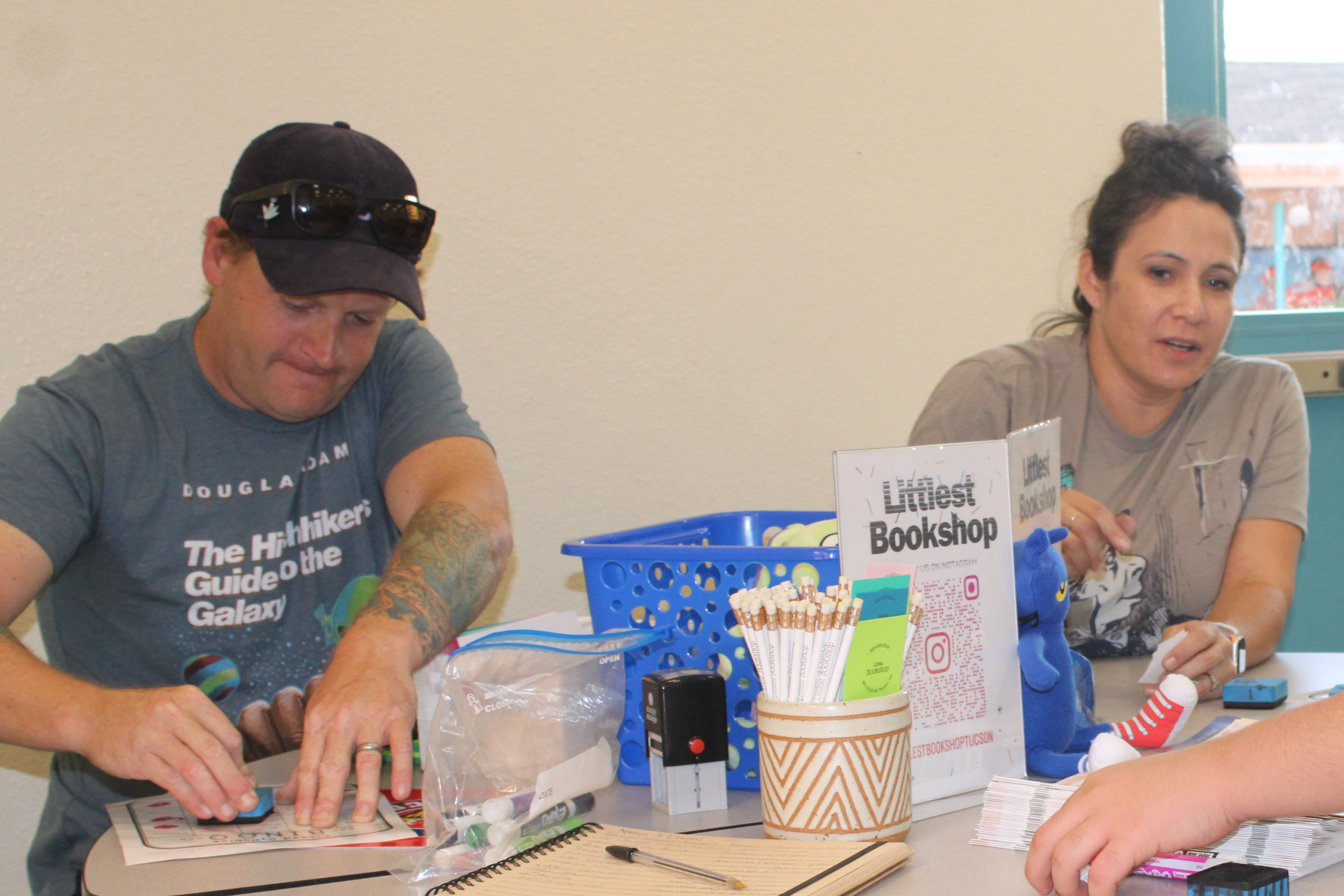 A dad and mom work on a craft at the event