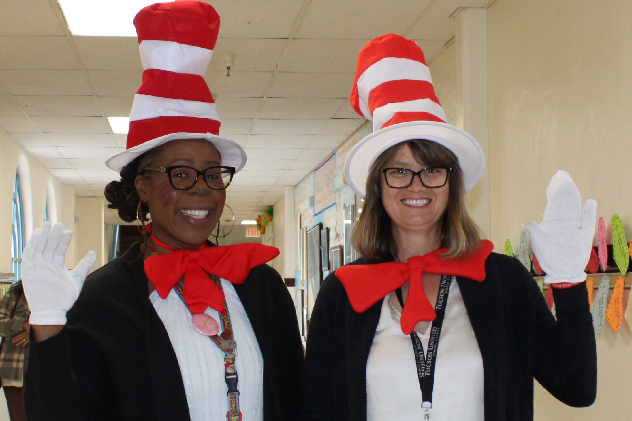 Two women smile in their Cat in the Hat costumes