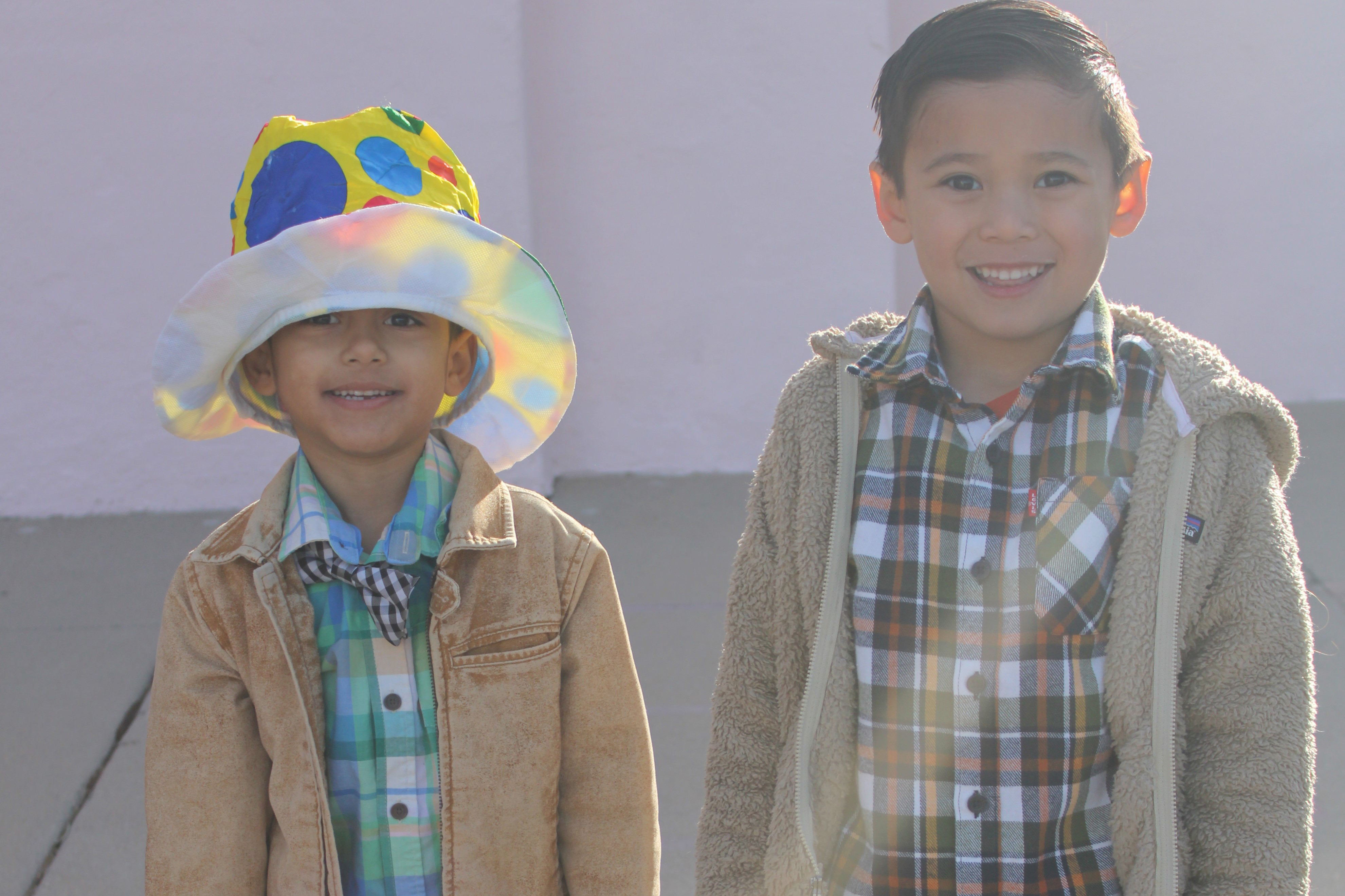 Two little boys smile in their western wear