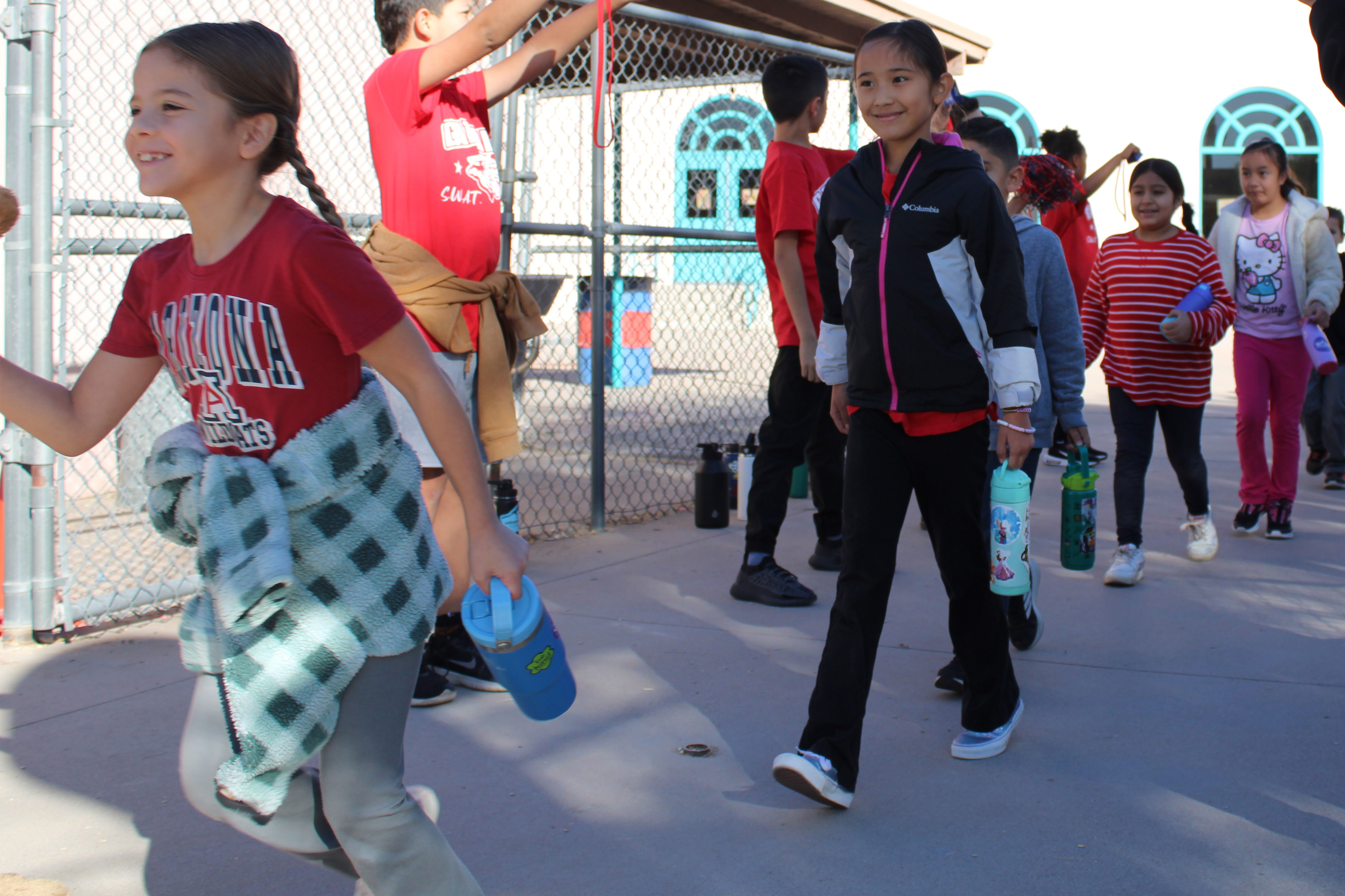 Students run through the tunnel of supporters