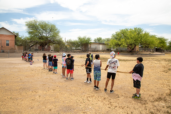 Students play tug of war on the field