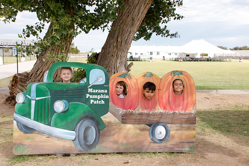 Four kids pose behind the Marana Pumpkin Patch truck