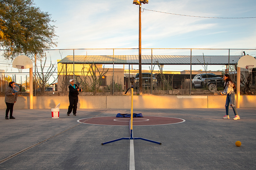 Students learn how to play tennis
